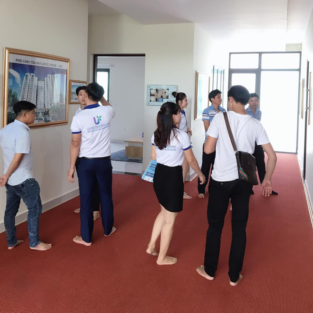 hinh anh dong phuc nhan vien nam son land can ho unico thang long